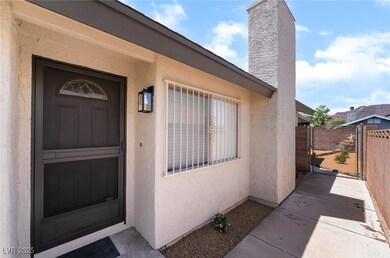Doorway to property featuring stucco siding, a gat