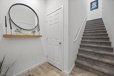 Stairs featuring wood finished floors and baseboar