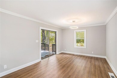 Empty room featuring wood-type flooring and orname