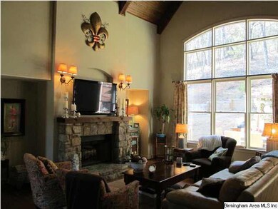 Two Story Great Room featuring Stone Surround Wood