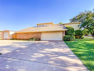 View of front of property featuring concrete drive