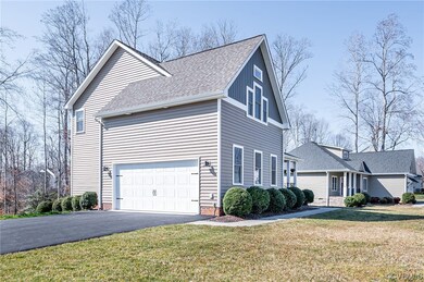 View of side of property featuring a yard and fini
