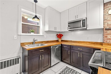 Stainless steel applicance, black cabinets and war