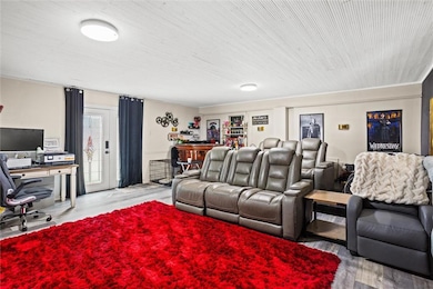 Living area with a desk, wood finished floors, and wooden ceiling