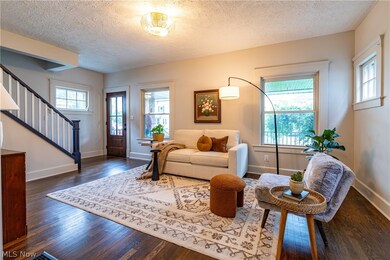 Living room with dark hardwood / wood-style flooring and a textured ceiling