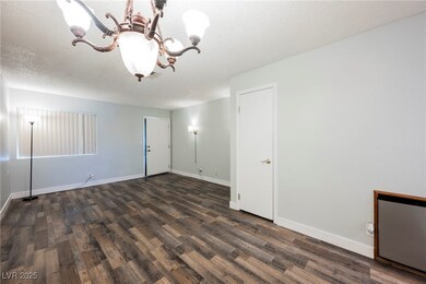 Empty room with baseboards, dark wood-style floori