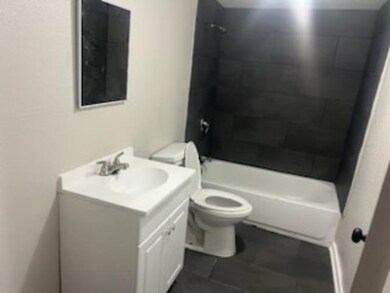 Full bathroom featuring tile patterned floors, van