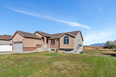 View of front of home featuring a front yard, concrete driveway, an attached garage, and brick siding