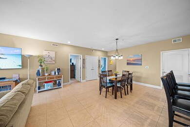 Tiled dining space featuring a notable chandelier