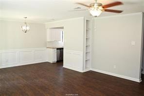 Empty room featuring ornamental molding, dark wood