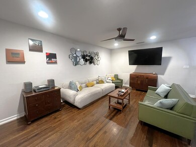 Living area with dark wood-type flooring, a ceili