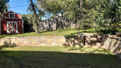 View of yard with a storage unit and a patio area