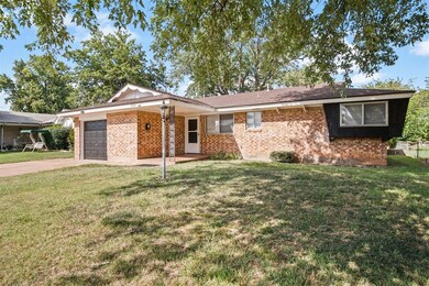 Ranch-style home with a garage and a front yard
