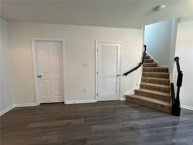 Stairs with wood finished floors and baseboards