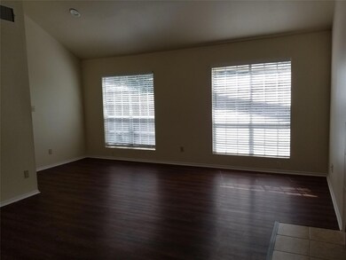Spare room with dark wood-type flooring and vault