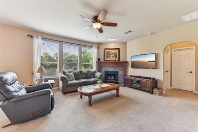 Living area featuring ceiling fan, light carpet, 