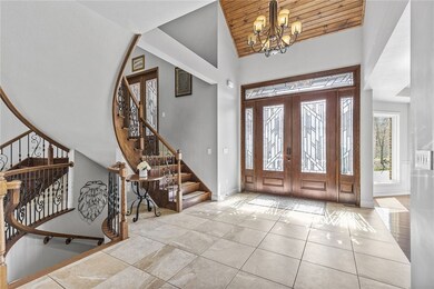 Bright entry with leaded glass doors and detailed