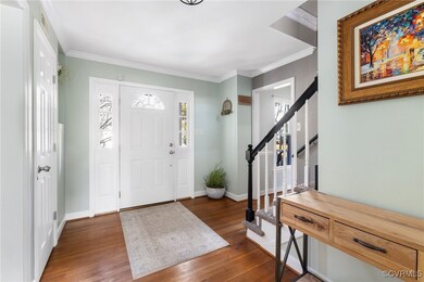 Foyer entrance with dark hardwood / wood-style flo