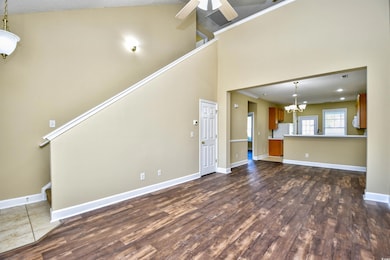 Unfurnished living room featuring a high ceiling, 