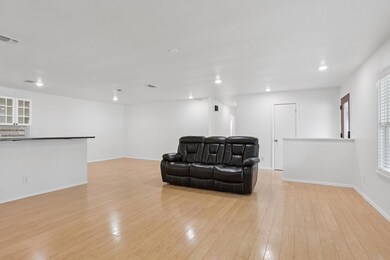 Sitting room with recessed lighting and light woo