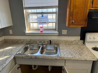 Kitchen featuring sink and white range with electr