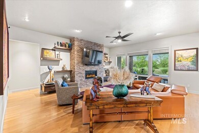 Living area featuring a fireplace, light wood-style floors, a ceiling fan, and recessed lighting