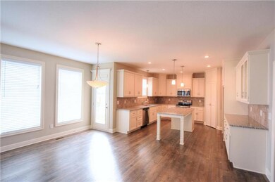 Chef's kitchen with island and open to the large b