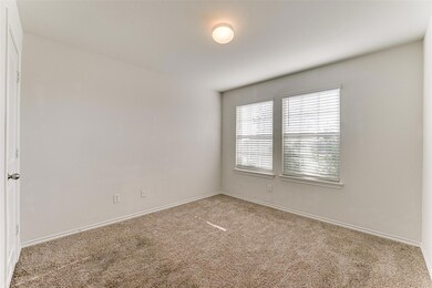 Carpeted spare room featuring baseboards