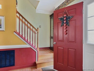 Entry foyer features hardwood floors, crown moldin