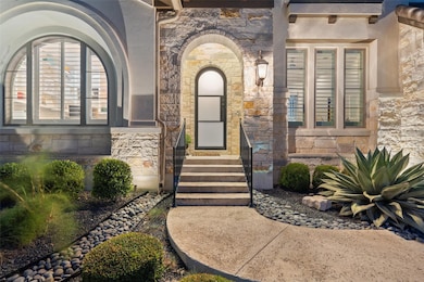 Entrance to property with stone siding and stucco