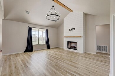 Unfurnished living room with high vaulted ceiling,
