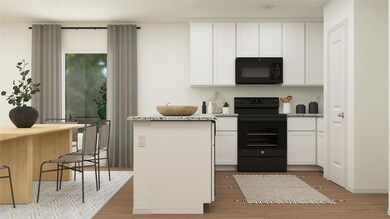 Kitchen with black appliances, light hardwood / wo