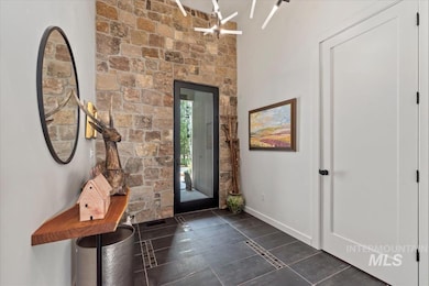 Entrance foyer featuring baseboards and dark tile patterned flooring