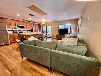 Living area featuring attic access, light wood fin