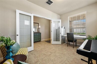 Home office with french doors and light tile patt