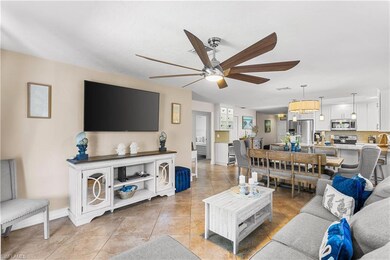 Tiled living room featuring ceiling fan