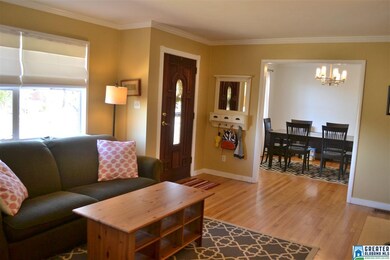 Living room with view of front door and dining roo