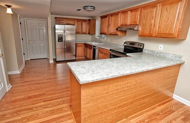 The kitchen features beautiful flooring and tons of cabinet & counter space.