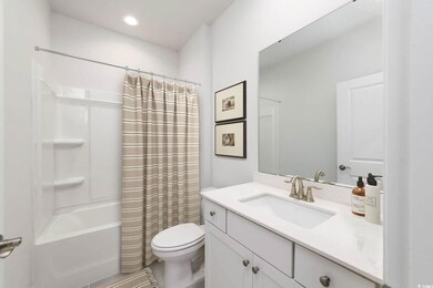Bathroom featuring toilet, vanity, shower / bathtu