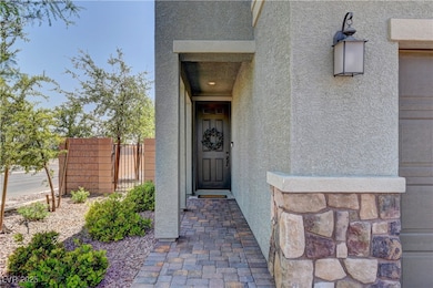 Property entrance featuring stucco siding and ston