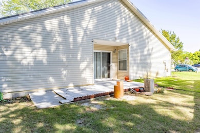 Rear view of property with a lawn
