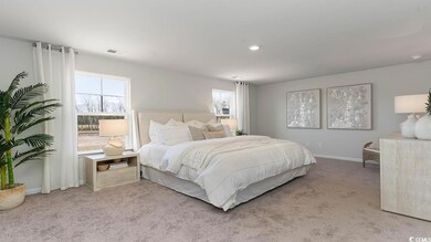 Bedroom featuring light carpet