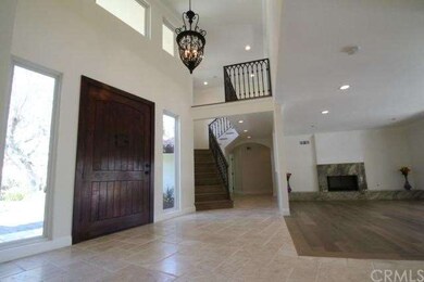 Large wood front door to be greeted by high ceilin