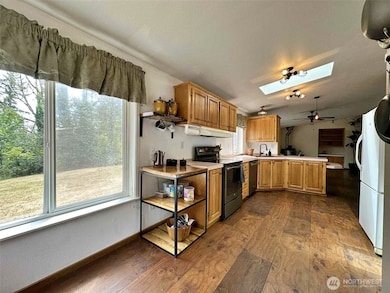 The views from the kitchen include the pond, trees, and yard.
