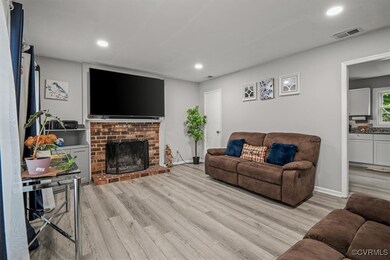 Living room with light hardwood / wood-style floor