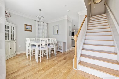 Dining space with crown molding, an inviting chand