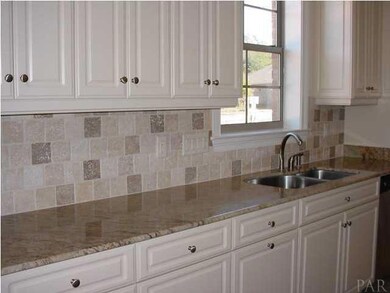 Tumbled stone backsplash compliments the granite counters.