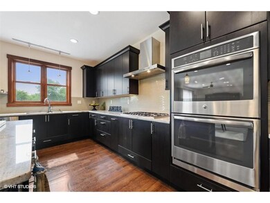 Double ovens, full size fridge in kitchen with sep