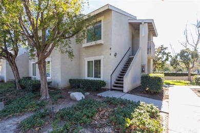 Lower level condo with windows in front, but entry to the side of the building.
