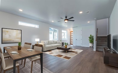 Living area featuring stairway, recessed lighting